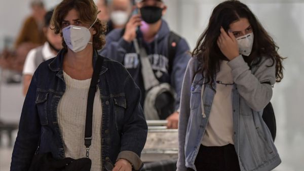 Passengers wearing masks as a precautionary measure to avoid contracting the new coronavirus, COVID-19, arrive on a flight from Italy at Guarulhos International Airport, in Guarulhos, Sao Paulo, Brazil on March 2, 2020. AFP