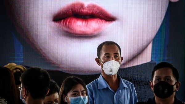 Commuters, wearing facemasks amid fears of the spread of the COVID-19 novel coronavirus (AFP)