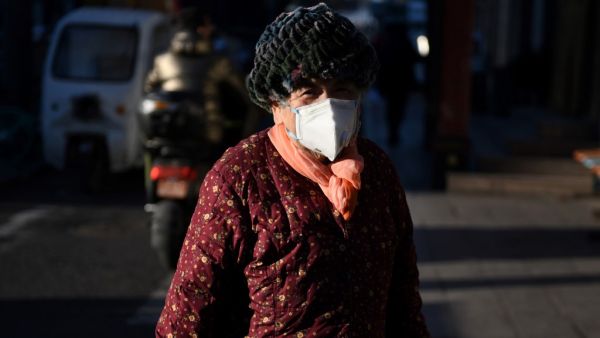A woman wears a face mask as a preventive measure against the COVID-19 coronavirus (AFP)