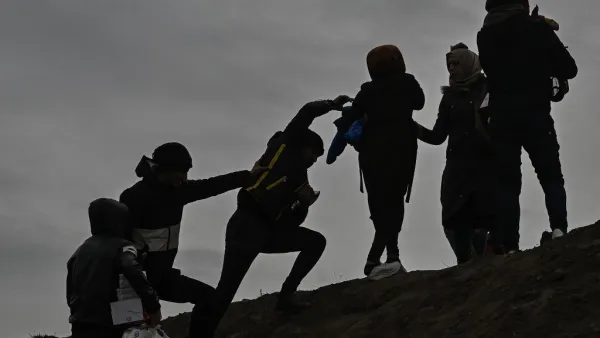 Migrants climb a hill as they gather near the Tunca river in the city of Edirne, northwest Turkey on March 5, 2020 waiting to resume their efforts to enter Europe near Pazarkule border gate. EU members on March 4, 2020 rejected what they said is Turkey's use of desperate migrants to pressure its neighbours -- and strongly backed Greece's border crackdown. The EU has scrambled to respond to the surge of migrants at the Greek border, where authorities say some 24,000 were stopped from entering between Februar