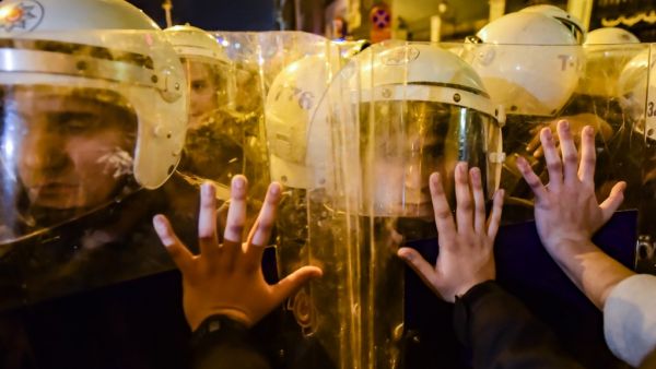 Turkish anti-riot police officers push back women during a rally marking International Women's Day on Istiklal avenue in Istanbul on March 8, 2020. Istanbul police fired tear gas at thousands of women who took to the city's central avenue on International Women's Day on March 8 in defiance of a protest ban to demand greater rights and denounce violence. Yasin AKGUL / AFP