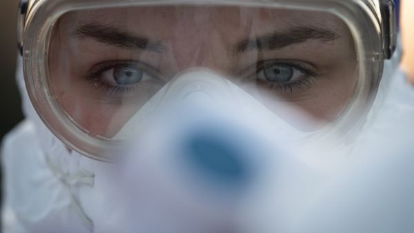 A medical worker wears protective goggles as she prepares to measure motorists' body temperatures at the Slovenian-Italian border crossing near Nova Gorica, on March 11, 2020, after Slovenia's government announced it would close its border with Italy, hard hit by the outbreak of COVID-19, the new coronavirus. Italy's neighbours Austria and Slovenia announced on March 10 Tuesday strict travel restrictions and other measures in the wake of similar moves by Rome to limit the spread of the new coronavirus. Jure
