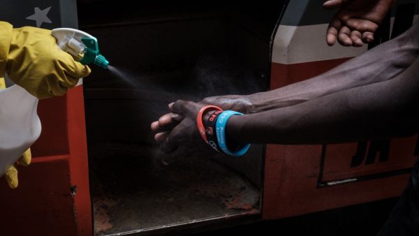 A staff member of Matatu, a privately owned minibus, provides hand disinfectant to passengers, as a preventative measure after the first Kenyan patient with the COVID-19 coronavirus was announced last week, in downtown Nairobi, Kenya, on March 16, 2020. Yasuyoshi CHIBA / AFP