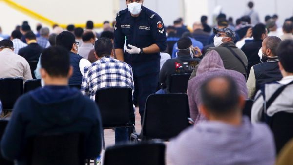 Expatriate returning from Egypt, Syria, and Lebanon arrive to be re-tested at a Kuwaiti health ministry containment and screening zone for COVID-19 coronavirus disease in Kuwait City on March 16, 2020. AFP/File