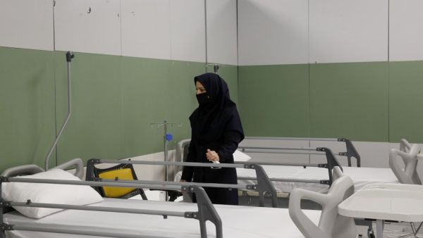 An Iranian health inspector checks a makeshift hospital set up inside the Iran Mall, northwest of Tehran, on March 21, 2020 amid the coronavirus outbreak. Iran said that 123 more people had died from coronavirus, raising the official death toll to 1,556 in the Islamic republic, one of the world's worst affected countries. STR / AFP