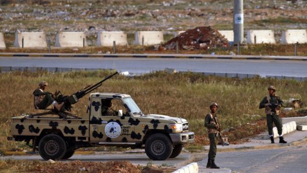 Fighters of a military battalion loyal to Libyan General Khalifa Hafta patrol the streets in the eastern city of Benghazi during a state of emergency to combat the coronavirus disease (COVID-19) outbreak, on March 21, 2020. Abdullah DOMA / AFP