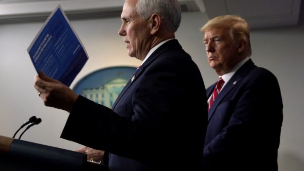 U.S. Vice President Mike Pence speaks as President Donald Trump listens during a news briefing on the latest development of the coronavirus outbreak in the U.S. at the James Brady Press Briefing Room at the White House March 20, 2020 in Washington, DC. ALEX WONG / GETTY IMAGES NORTH AMERICA / AFP