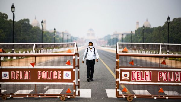 A man walks on a closed road leading to the Presidential Palace in New Delhi on March 24, 2020. India has instated a government-imposed lockdown for 30 days. Jewel Samad/AFP via Getty Images