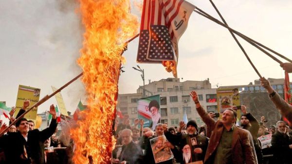 Iranian pro-government demonstrators burn makeshift US flags in Tehran. (AFP)