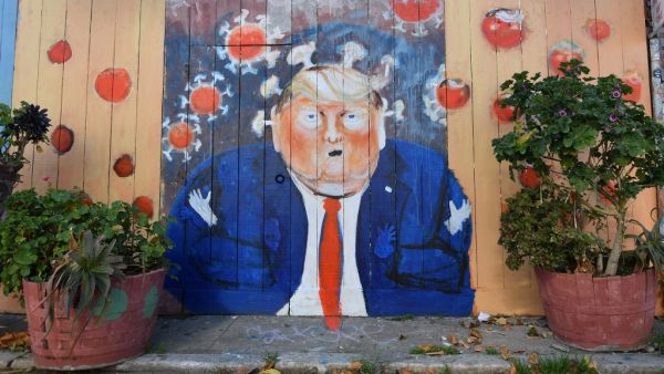 A mural painted on a fence depicts US President Donald Trump as the Coronavirus in San Francisco, California on April, 01, 2020. All 40 million residents of California were Thursday ordered to stay at home indefinitely in a bid to battle the coronavirus pandemic in the nation's most populous state. Josh Edelson / AFP