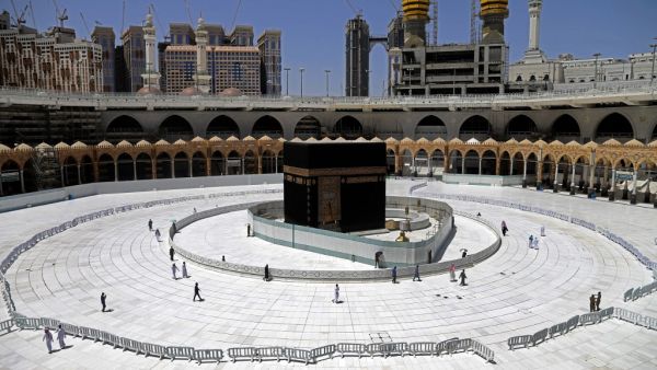 Muslim worshippers circumambulate the sacred Kaaba in Mecca's Grand Mosque, Islam's holiest site, on April 3, 2020. Saudi Arabia on April 2 extended curfew restrictions on Islam's two holiest cities to 24 hours to stem the spread of coronavirus as the number of deaths from the disease rose to 21. AFP