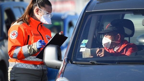 A member of Red Cross ask questions to a man repatriated from Morocco by ferry, around 600 people from European Union and around 230 vehicles arrived at the Sete harbour, southwest of Montpellier, on April 4, 2020, during the strict lockdown in France to stop the spread of the novel coronavirus COVID-19. Sylvain THOMAS / AFP