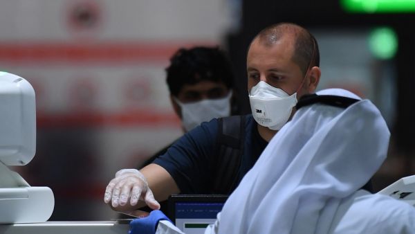 Passengers have their travel documents checked before departure at Dubai International Airport in the gulf emirate on April 6, 2020, as Emirates airline resumed a limited number of outbound passenger flights after its COVID-19 coronavirus-enforced stoppage. KARIM SAHIB / AFP