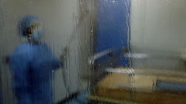 A man disinfects an intesive care isolation room at the Rafik Hariri public hospital in the Lebanese capital Beirut on April 7, 2020. The Mediterranean country announced a lockdown and closed its airport as of March 19 as part of measures to curb the spread of COVID-19, which has officially infected 548 people and killed 18 nationwide. JOSEPH EID / AFP