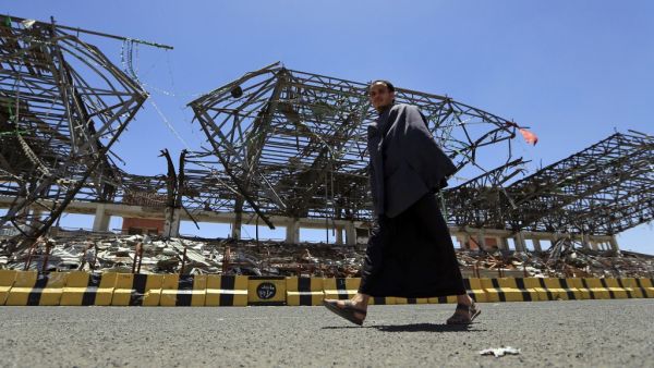 A man walks past a popular public square, which was destroyed late 2017 in an airstrike by the Saudi-led coalition, in the capital Sanaa on April 9, 2020. The Saudi-led coalition began a unilateral ceasefire in Yemen's long war, saying it hoped the initiative to prevent coronavirus in the impoverished country would lead to a wider political solution.  MOHAMMED HUWAIS / AFP