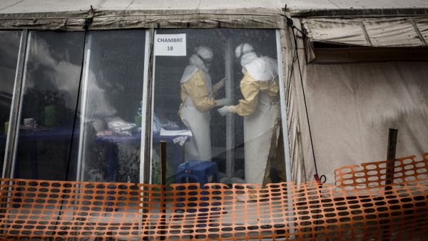 In this file photo taken on March 09, 2019 Health workers are seen inside the 'red zone' of an Ebola treatment centre, which was attacked in the early hours of the morning in Butembo. AFP/File