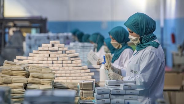 Factory workers package disposable protective masks along a production line in Morocco's Casablanca on April 10, 2020, as the North African country increases mask production due to the COVID-19 coronavirus pandemic. FADEL SENNA / AFP