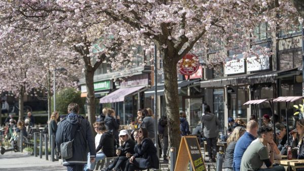 People sit at a cafe terrasse in central Stockholm, Sweden, on April 11, 2020 amid the new coronavirus COVID-19 pandemic. Sweden has not imposed extraordinary lockdown orders seen elsewhere in Europe to stem the spread of the virus, instead calling for citizens to take responsibility to follow social distancing guidelines. Anders WIKLUND / TT News Agency / AFP