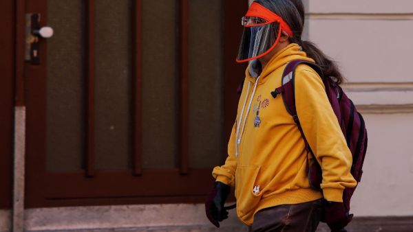 A person wears a visor as a face protection in Berlin's Kreuzberg district on April 11, 2020 amid the novel coronavirus, COVID-19, pandemic. David GANNON / AFP