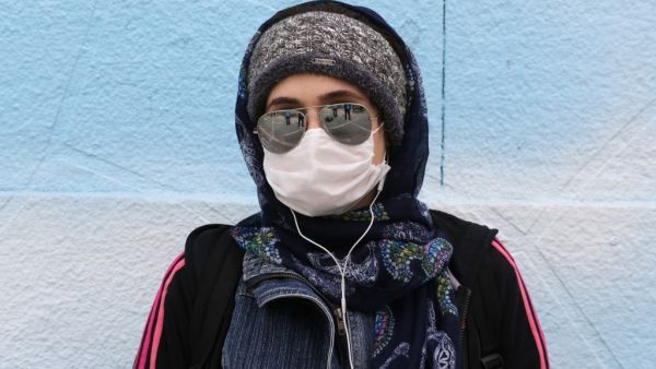 An Iranian woman wearing a protective mask poses for a picture in Tehran on April 13, 2020 during the coronavirus COVID-19 pandemic. The Islamic republic said on April 14 that the number of lives lost in the country to the novel coronavirus dropped to double figures for the first time in one month. Health ministry spokesman Kianoush Jahanpour said 98 deaths from the COVID-19 disease were recorded in the past 24 hours, bringing the overall toll to 4,683.  ATTA KENARE / AFP