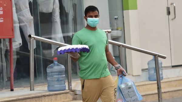 A worker delivers groceries during a nationwide curfew to stem the spread of COVID-19 in the Saudi capital Riyadh on April 13, 2020, ahead of the holy Muslim fasting month of Ramadan. (AFP)