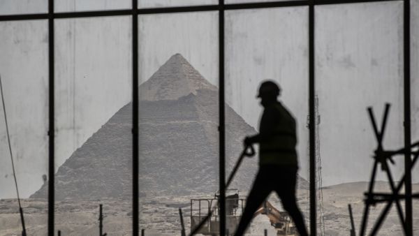 A picture taken on April 13, 2020, shows a view of the Great pyramid of Khafre (Chephren) seen through the scaffolding on the Grand Egyptian Museum (GEM), which is currently under construction, in Giza on the southwestern outskirts of the capital Cairo. Khaled DESOUKI / AFP