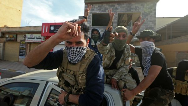 Fighters loyal to the UN-recognised Government of National Accord (GNA) gesture in celebration in the coastal city of Sabratha on April 13, 2020, after it seized two coastal cities between Tripoli and the Tunisian border from troops backing military commander Khalifa Haftar. "Our forces took control of Sorman and Sabratha and are pursuing (Haftar's forces)," said a statement by Mohammed Gnunu, spokesman for the forces of the United Nations-recognised Government of National Accord. Control of war-torn Libya 
