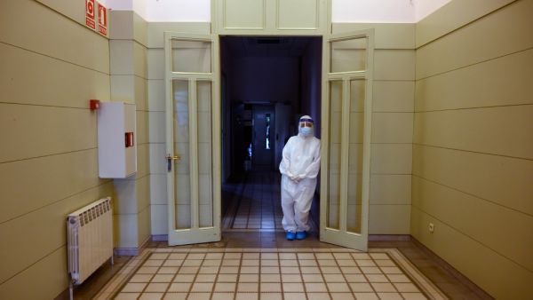 A healthcare worker wearing a protective suit waits during a COVID-19 coronavirus testing campaign at the Hospital Sant Miquel care home for the elderly in Barcelona on April 15, 2020. Spain recorded 523 deaths from the coronavirus on Wednesday, a decline from the previous day, but the number of new daily confirmed cases was the highest in six days. LLUIS GENE / AFP