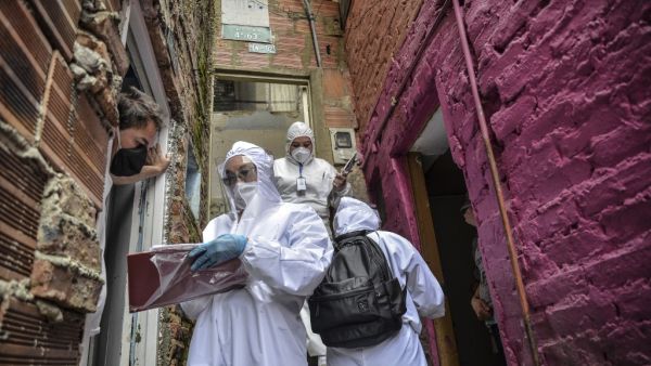 Workers of Bogota's Mayor's office wear protective suits to avoid getting infected with COVID-19 as they conduct a census at Egipto (Egypt) neighbourhood in Bogota on April 19, 2020 to know how many families need to be provided with food to prevent them from go shopping during the new coronavirus pandemic. The number of coronavirus infections across Latin America surpassed 100,000 on Sunday with nearly 5,000 deaths, according to an AFP tally based on official figures reported by individual countries. Diana 