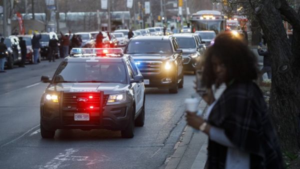 A convoy of Toronto Police vehicles is seen as Toronto first responders parade down hospital row in Toronto, Ontario, Canada, in a salute to healthcare workers on April 19, 2020, amid the novel coronavirus pandemic. (AFP)