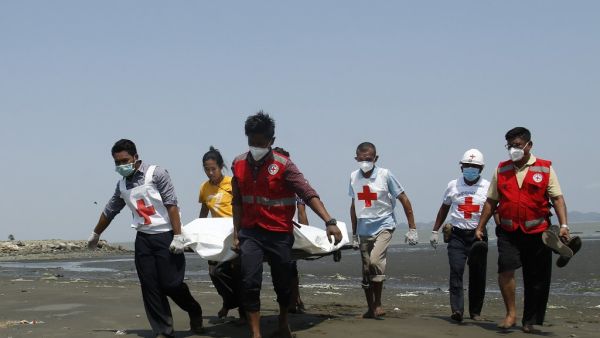 Members of the Myanmar Red Cross carry the body of the driver of a United Nations-marked vehicle after it came under attack while delivering test samples for the COVID-19 coronavirus, in Sittwe, Rakhine State on April 21, 2020. (AFP)