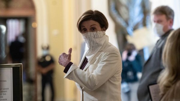US House Speaker Nancy Pelosi walks to the chamber of the US House of Representatives start of a vote on the additional 484 billion dollar relief package amid the coronavirus pandemic at the US Capitol in Washington, DC, on April 23, 2020. NICHOLAS KAMM / AFP