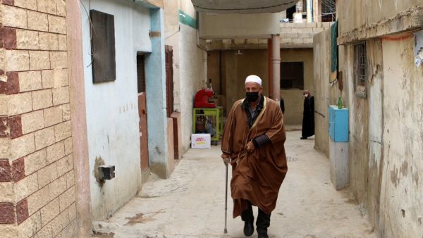 An Elderly man wearing a face mask walks through an alley at the Wavel Palestinian refugee camp (also known as the Jalil camp) in Lebanon's eastern Bekaa Valley, on April 24, 2020, after cases of infection by the novel coronavirus were detected there. The residents of the Wavel camp were tested after a member of a household, a Palestinian refugee from Syria, was admitted to the state-run Rafic Hariri hospital in the capital Beirut for demonstrating COVID-19 symptoms. AFP