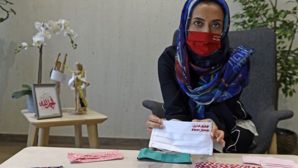 Bahraini entrepreneur Noor Khamdan displays protective masks designed by her at a workshop in Abu Saiba village in the northern part of Bahrain, west of the capital city Manama, amid the COVID-19 pandemic on April 25, 2020. Mazen Mahdi / AFP