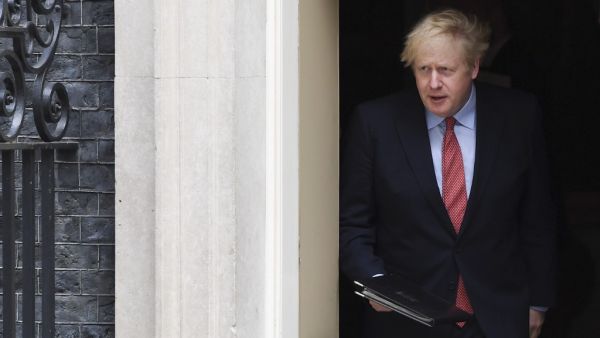 Britain's Prime Minister Boris Johnson walks out of 10 Downing Street to give a statement in central London on April 27, 2020 after returning to work following more than three weeks off after being hospitalised with the COVID-19 illness. (AFP)