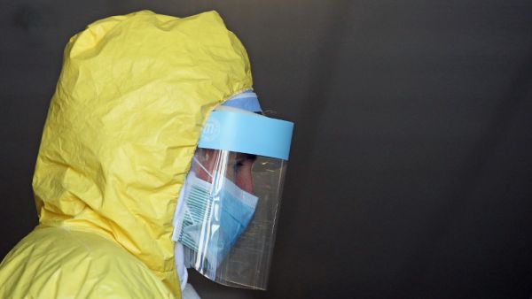 Dr. Cory Baker tends to a patient at a ProHEALTH Care coronavirus testing site on April 15, 2020 in New Hyde Park, New York. Long Island now has multiple sites for drive-thru COVID-19 testing. Bruce Bennett/Getty Images/AFP BRUCE BENNETT / GETTY IMAGES NORTH AMERICA / Getty Images via AFP