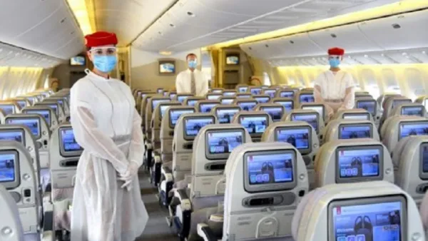 Emirates crew onboard wear a protective disposable gown over their uniforms and a safety visor in addition to masks and gloves.