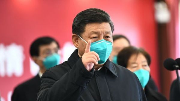 Chinese President Xi Jinping gestures to a coronavirus patient and medical staff via a video link at the Huoshenshan hospital in Wuhan on Tuesday. Photograph: Xie Huanchi/Xinhua/AFP via Getty Images
