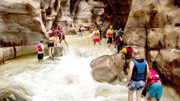 A group of adventurers battle raging waters at Wadi Mujib. (Credit: Wild Jordan)