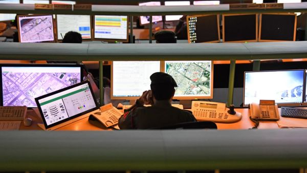 Police officers monitor the streets and receive calls from citizens at the Command and Control Center of Dubai Police in the Gulf emirate, on February 24, 2020. The novel coronavirus has given the Gulf emirate of Dubai an opportunity to showcase its technological and scientific clout as it seeks to shape its own model for approaching the pandemic. KARIM SAHIB / AFP