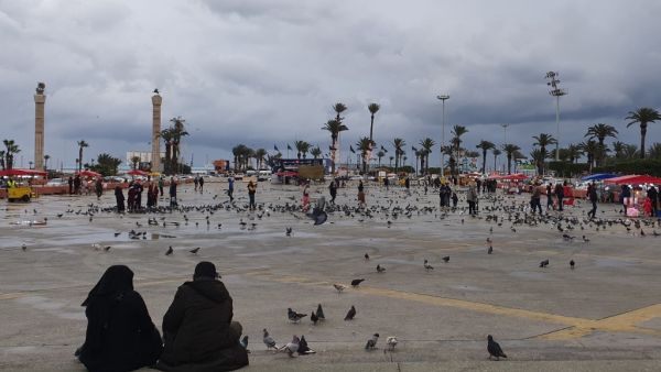 Libyans sit at Martyrs square in the capital Tripoli on March 10, 2020. According to Libyan authorities, not a single case of coronavirus so far has been recorded in the country which faces Italy across the Mediterranean. (AFP/File)