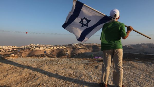  this file photo taken on September 7, 2009 a right wing Israeli boy holds his national flag during a protest near the biggest Jewish settlement of Maale Adumim, east of Jerusalem. (AFP/File Photo)
