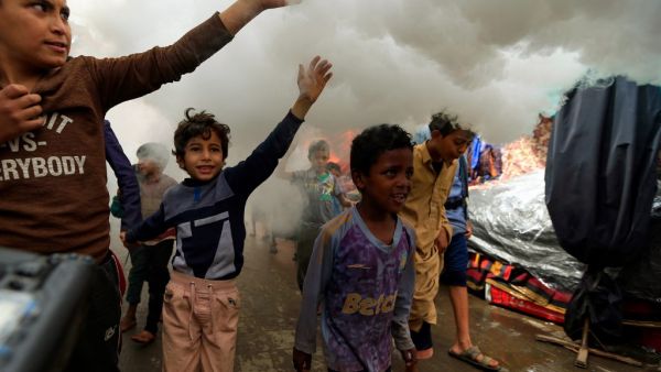 Yemeni children react as municipal workers fumigate a street in the old city market of the capital Sanaa, with a disinfectant substance against the novel coronavirus, on April 30, 2020. Yemen has been largely spared from the effects of the pandemic, with a total of six cases recorded so far -- the first in April in the government-controlled southeastern province of Hadramawt. Mohammed HUWAIS / AFP