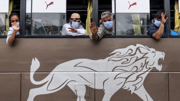 Native Kashmiri passengers wave from the windows of a special service bus about to leave for Jammu and Kashmir state during a government-imposed nationwide lockdown as a preventive measure against the COVID-19 coronavirus, in Amritsar on May 3, 2020. NARINDER NANU / AFP