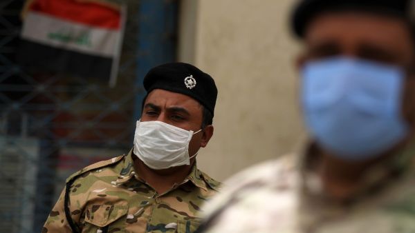 Members of the Iraqi security forces wearing a protective masks and gloves stand guard in the capital Baghdad's Tahrir square on May 5, 2020, during the novel coronavirus pandemic crisis. (AFP/File)
