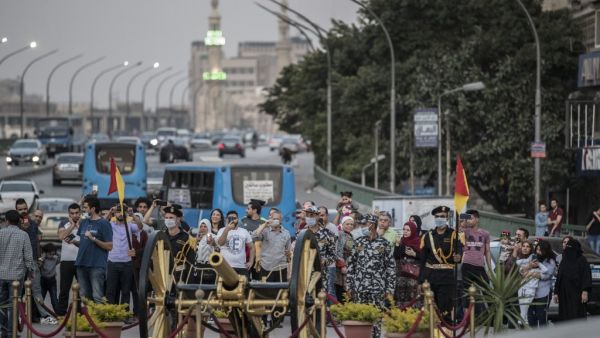 Members of the Egyptian security forces wearing masks against the coronavirus Covid-19 prepare to fire a Ramadan cannon to mark the breaking of the fasting during the Muslim holy month of Ramadan at Giza district in the Egyptian capital Cairo on May 7, 2020. Khaled DESOUKI / AFP