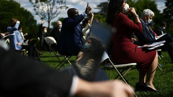Reporters wearing masks ask questions as US President Donald Trump speaks during a news conference on the novel coronavirus, COVID-19, in the Rose Garden of the White House in Washington, DC on May 11, 2020. Brendan Smialowski / AFP