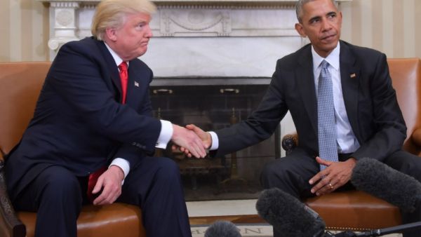 In this file photo US President Barack Obama and President-elect Donald Trump shake hands during a transition planning meeting in the Oval Office at the White House in Washington, DC. President Donald Trump broke with tradition on May 14 by calling for investigation of his White House predecessor Barack Obama in the latest attempt to push a conspiracy theory about his Democratic opponents. JIM WATSON / AFP