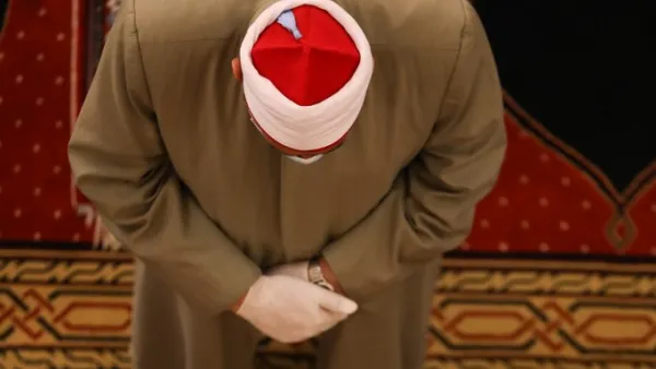 A Muslim cleric takes part in a morning prayer to celebrate the Eid al-Fitr holiday while wearing gloves and maintaining social distancing due to the COVID-19 pandemic, at Mohammed al-Amin Mosque in the Lebanese capital Beirut's downtown district on May 24, 2020. ANWAR AMRO / AFP