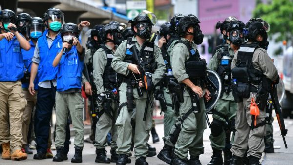 Riot police gather on a road as protesters take part in a pro-democracy rally against a proposed new security law in Hong Kong on May 24, 2020. The proposed legislation is expected to ban treason, subversion and sedition, and follows repeated warnings from Beijing that it will no longer tolerate dissent in Hong Kong, which was shaken by months of massive, sometimes violent anti-government protests last year. Anthony WALLACE / AFP